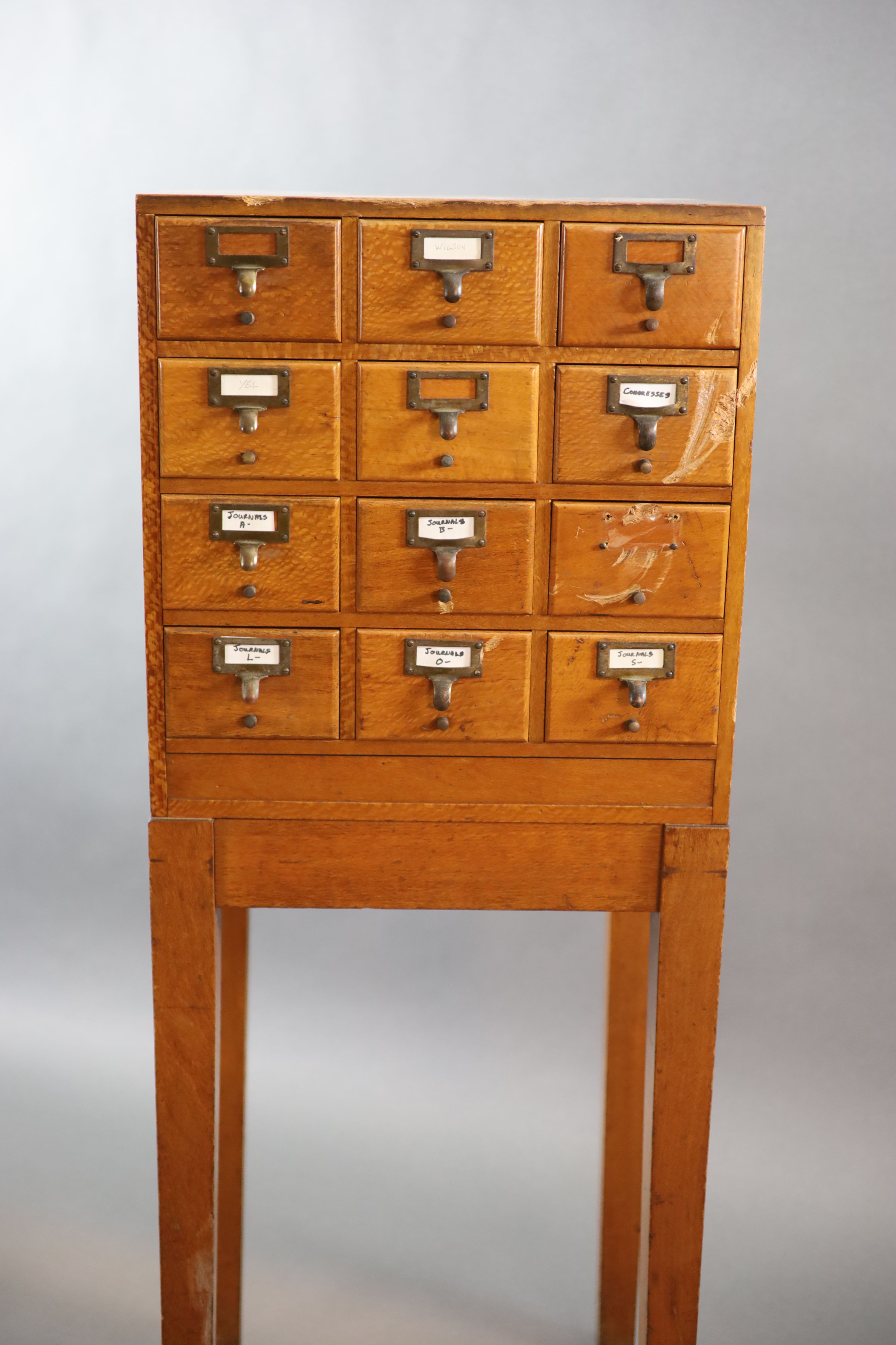 An early 20th century golden oak filing chest on stand, fitted twelve drawers, width 50cm depth 41cm height 131cm